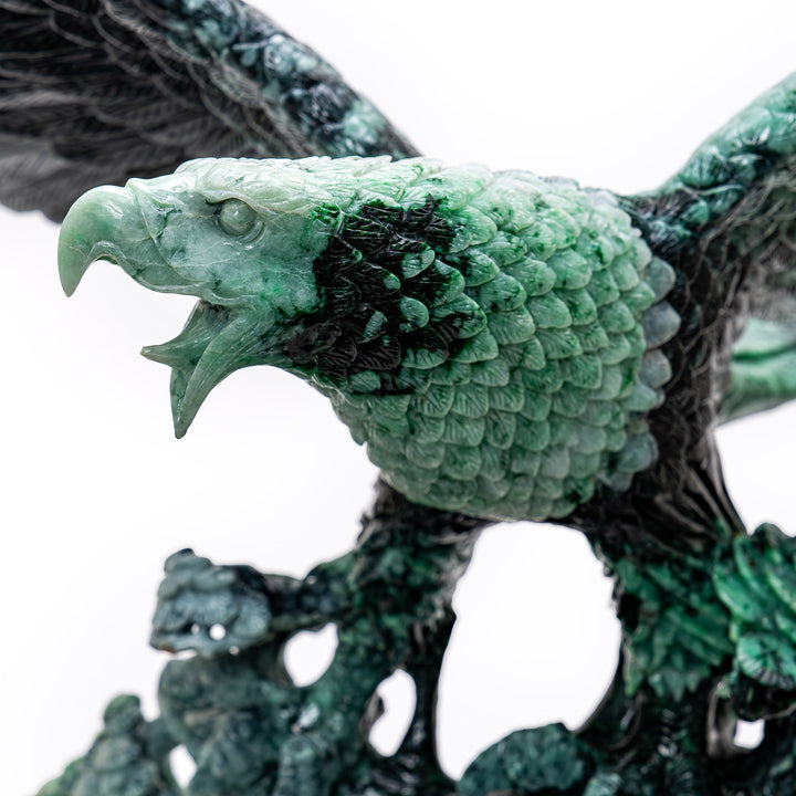 Dynamic and refined jade carving of a soaring eagle, representing focus and determination.