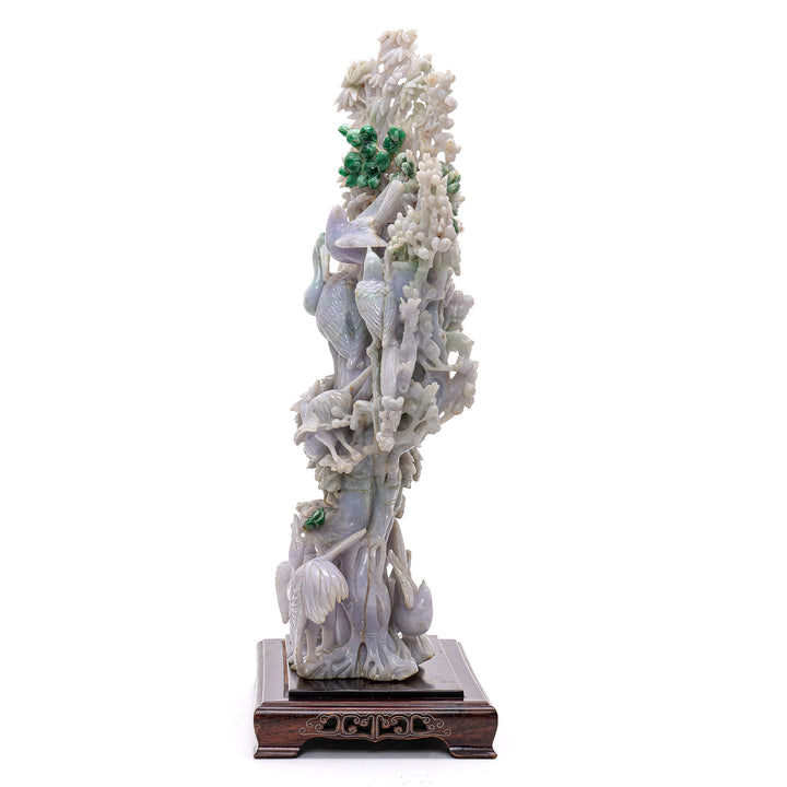 Intricately carved jade masterpiece with cranes in pale lavender and green coloration.
