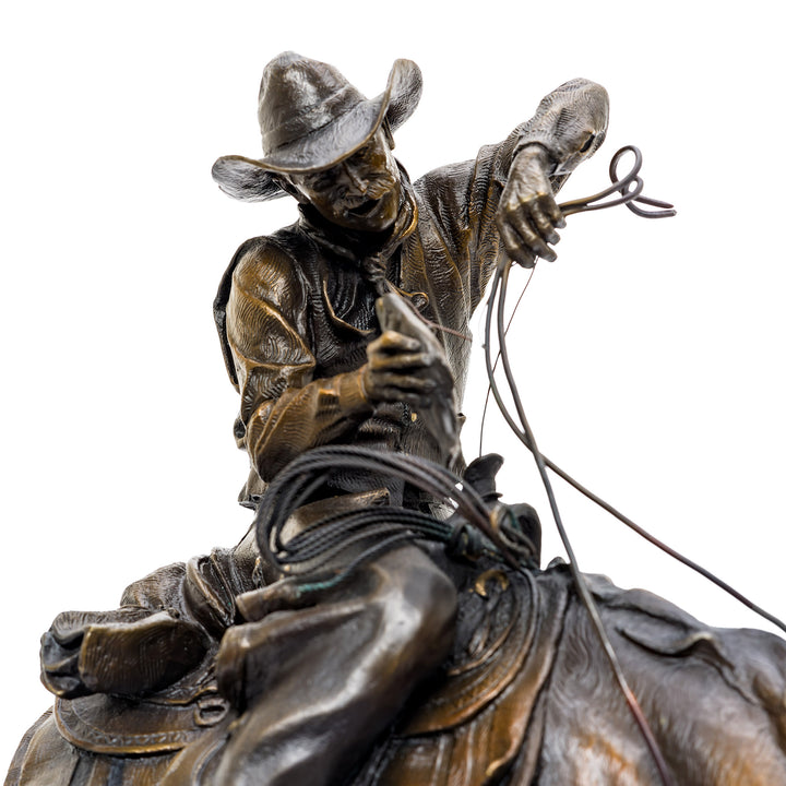 Dynamic bronze cowboy and horse sculpture signed by D. Michael Thomas