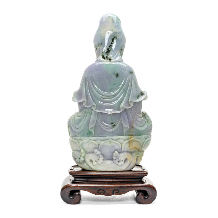 Divine jade sculpture of Kwan Yin on a wooden base.