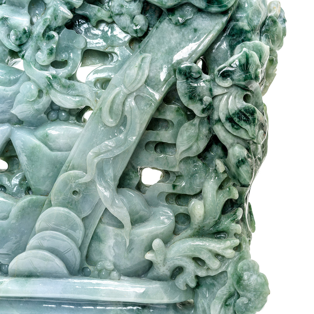 Artistic jade carving symbolizing wealth with Chinese coins.