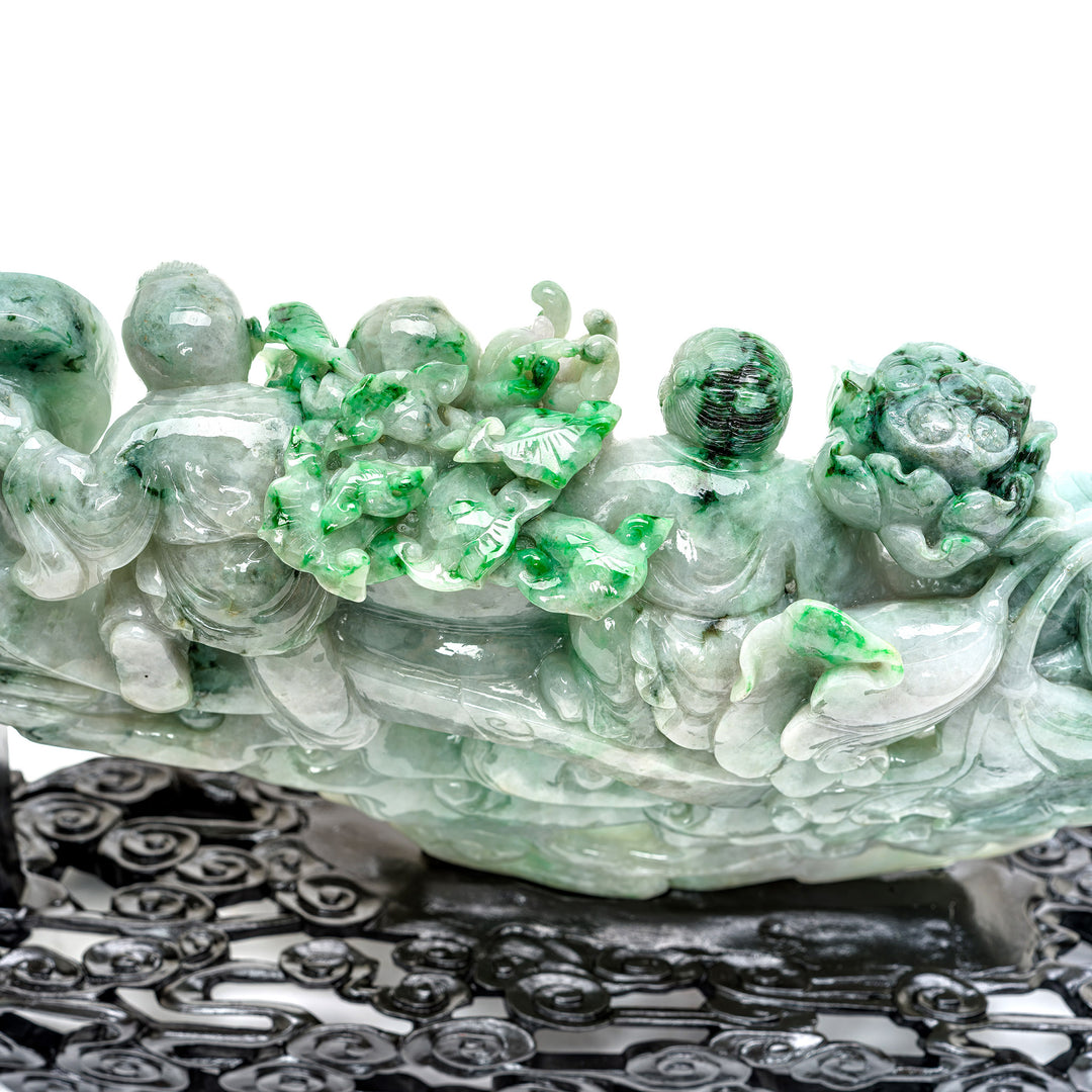 Artisan-crafted jade sculpture with joyful children figures.
