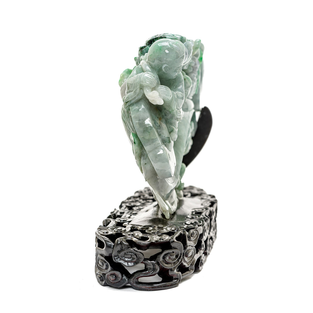 Unique jade children playing scene on a detailed scepter.