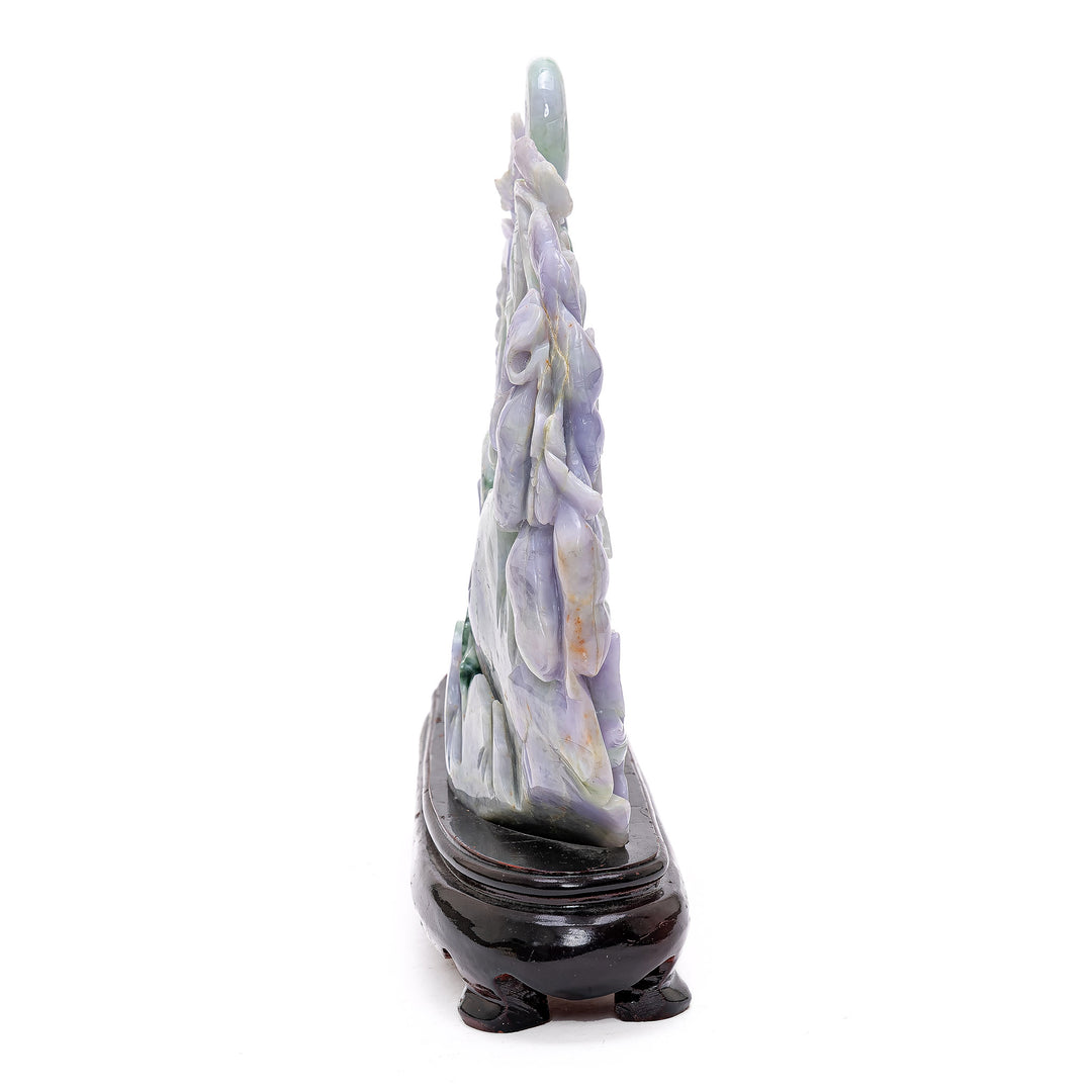 Detailed jade sculpture portraying geese in a serene setting with flourishing grapes