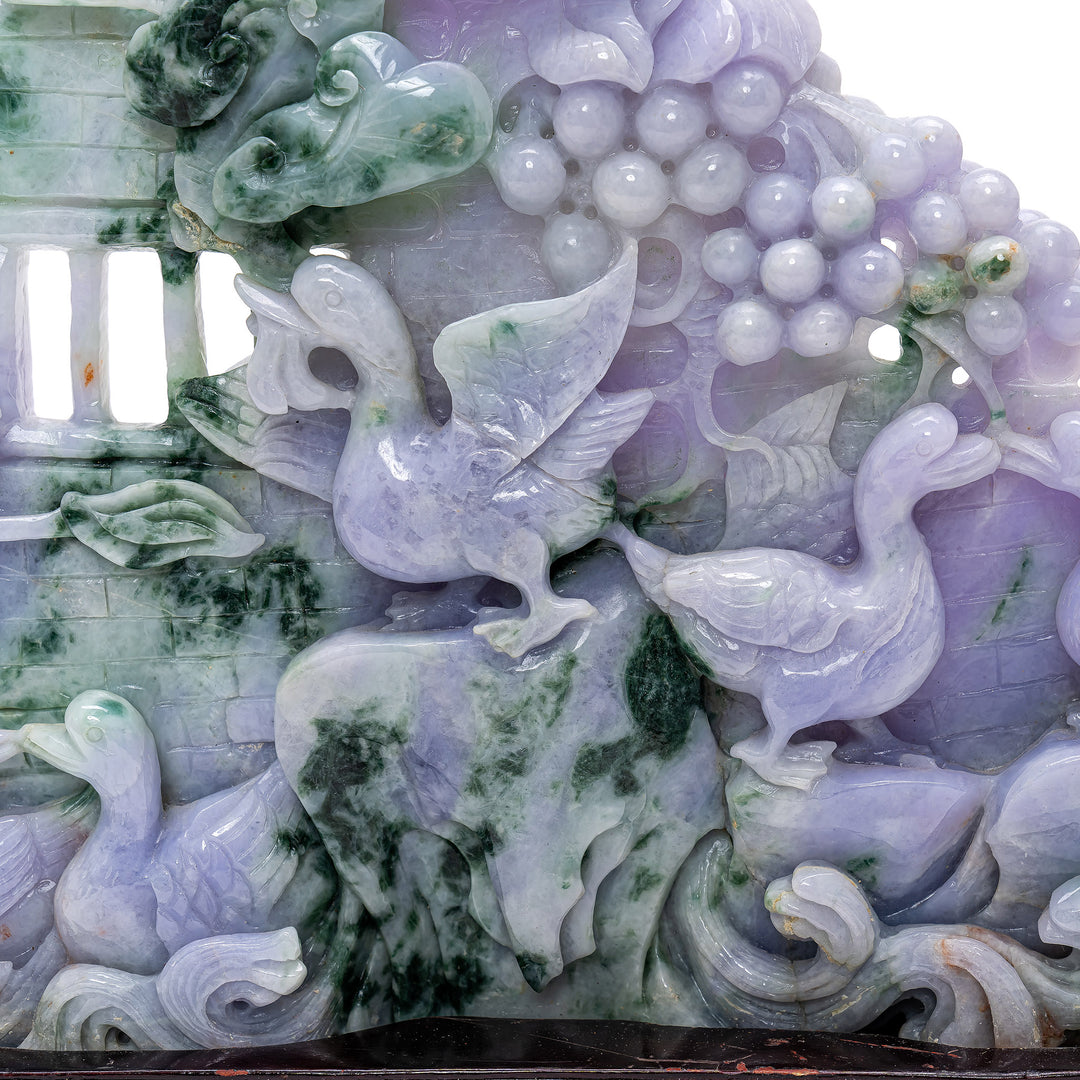 Sophisticated jade carving illustrating a harmonious scene of geese and grapes.