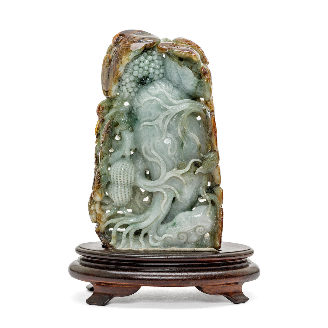 Miniature jade sculpture with detailed foliage and vegetation motif.