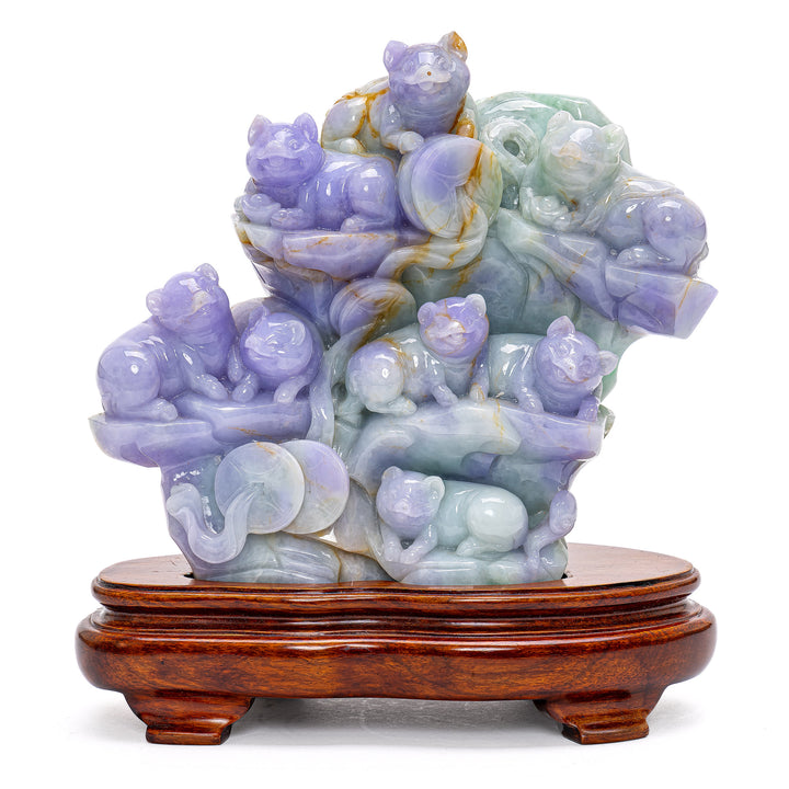 Exquisite jade pig sculpture portraying playful pigs on a serene mountainside.
