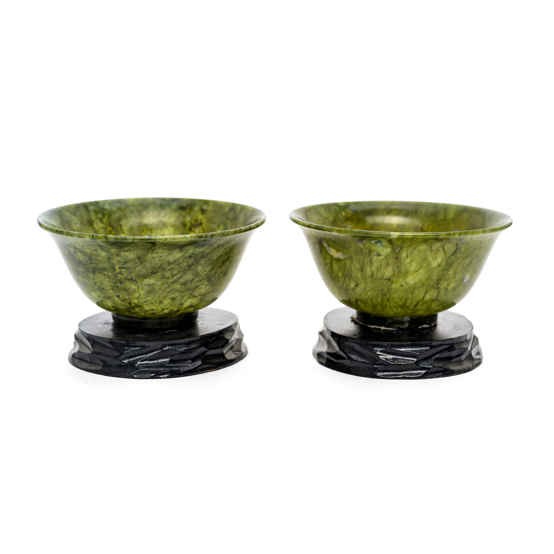 Elegant pair of spinach green bowls on wooden bases