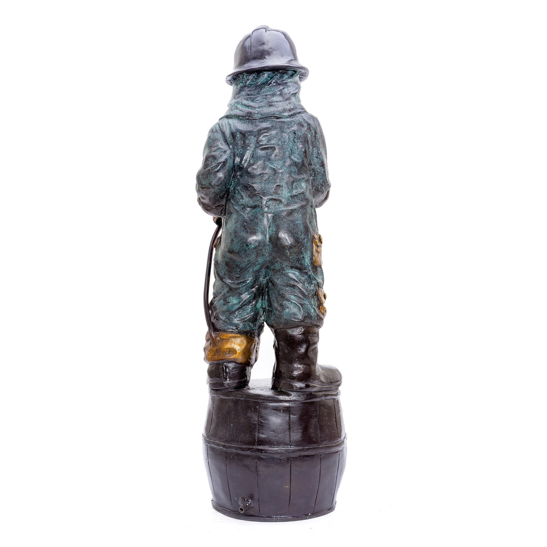 Collectible bronze figure of a child firefighter on a barrel.
