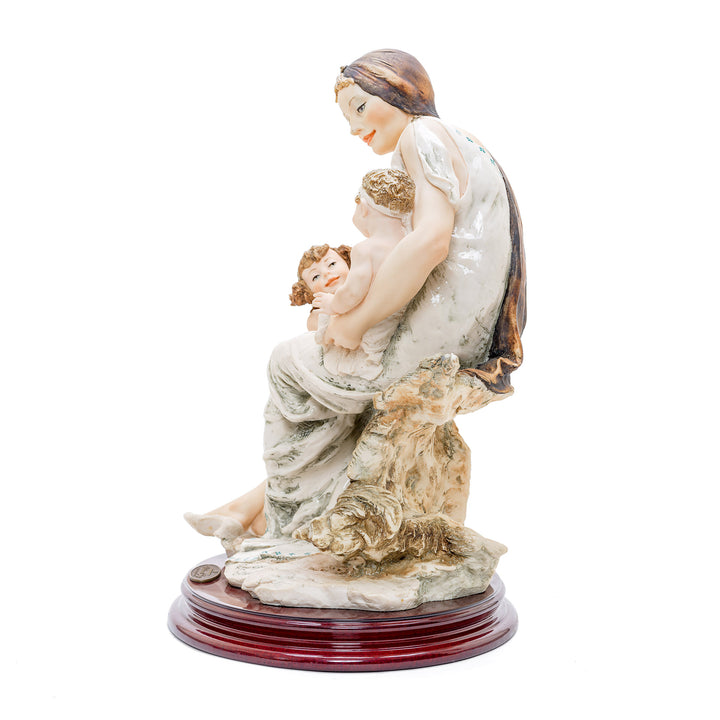 Porcelain sculpture of a mother with her children by Giuseppe Armani.