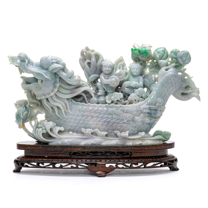 Hand-carved jade dragon boat with intricate details.