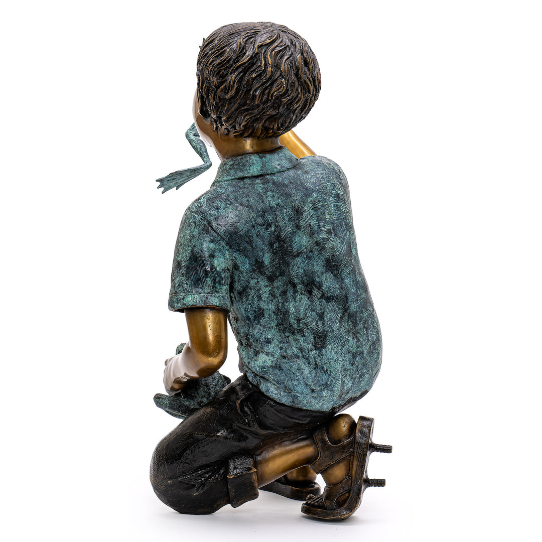 Kneeling boy in bronze discovering nature’s magic.