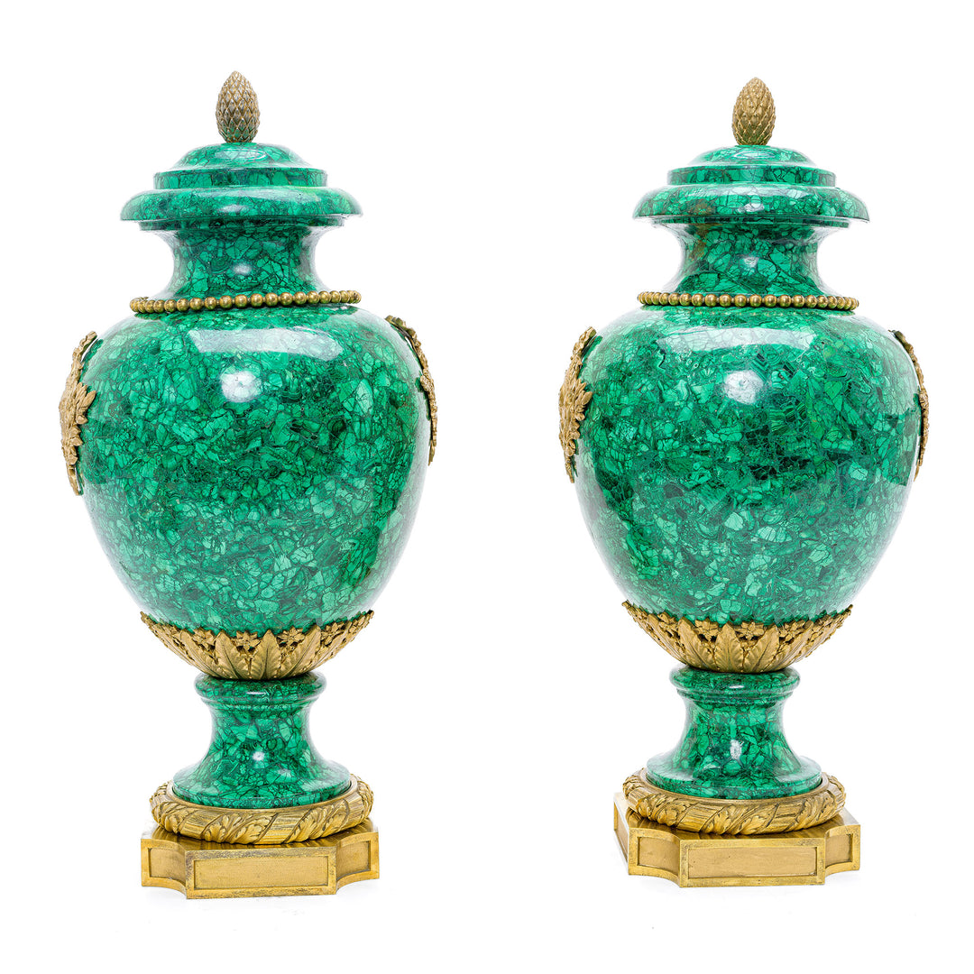 Exquisite malachite vases featuring detailed doré Roman motifs and acorn finial.