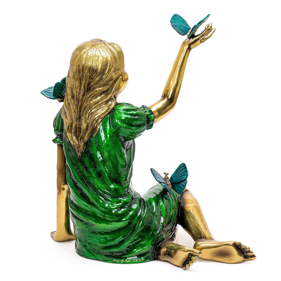 Seated girl in bronze, reflecting automotive luxury.