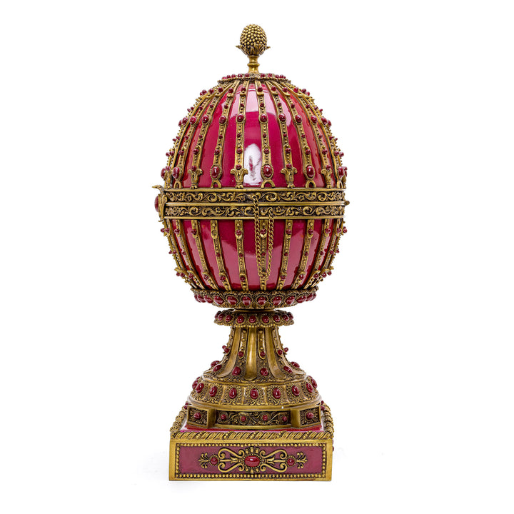 Elegant ornamental egg with doré bronze and porcelain cabochons, perfect for collectors.