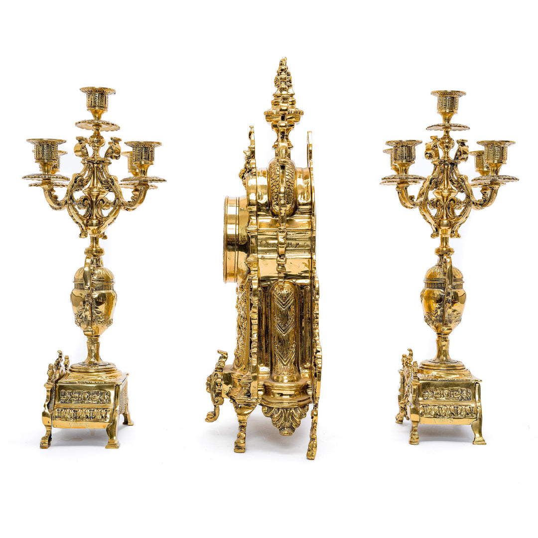 Ornate gilt bronze clock with classical urn design and foliate frame.