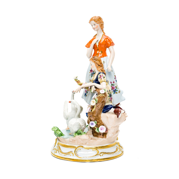 Elegant porcelain figurine depicting two ladies and swans.