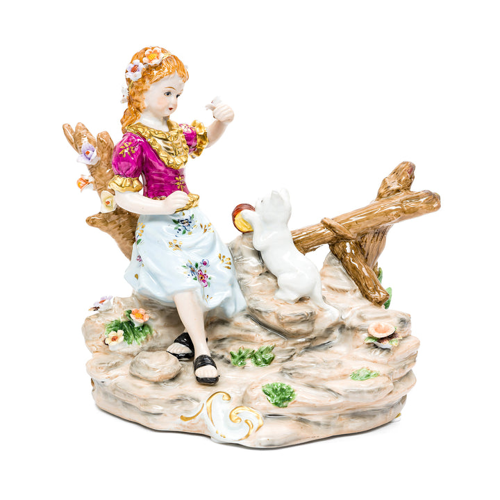 Delightful handmade porcelain sculpture of girl playing with cat.