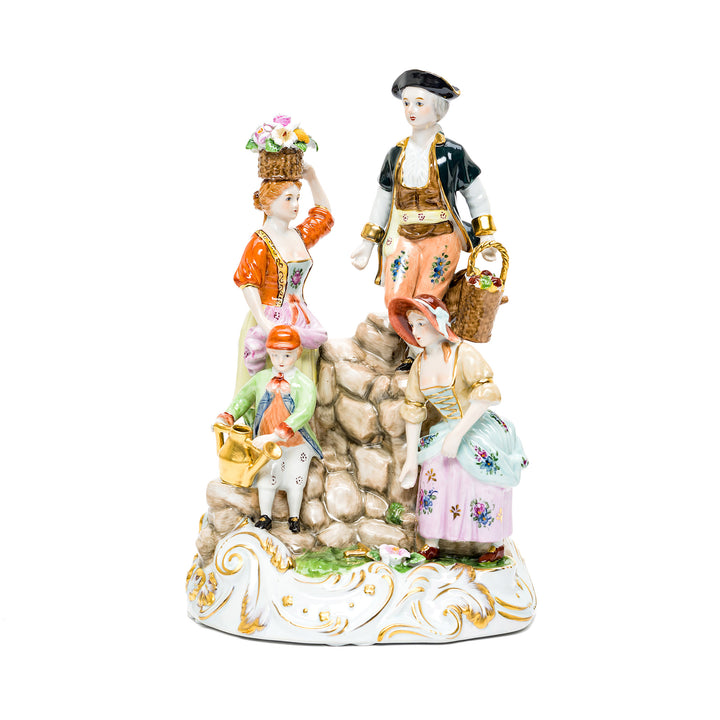 Handmade porcelain sculpture of a family in the garden