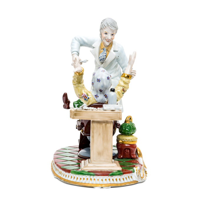 Detailed porcelain dentist figurine with patient