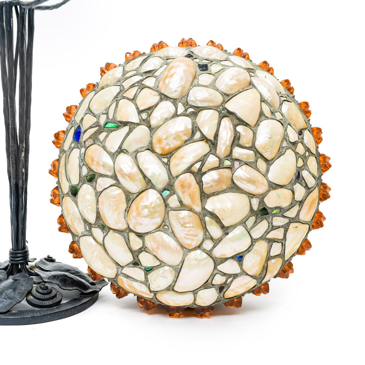 Decorative lamp with pebble mosaic design on a white background