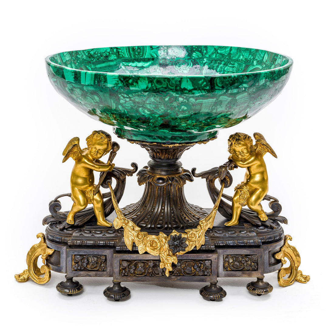 Malachite centerpiece bowl with gilt cherubs on bronze base.