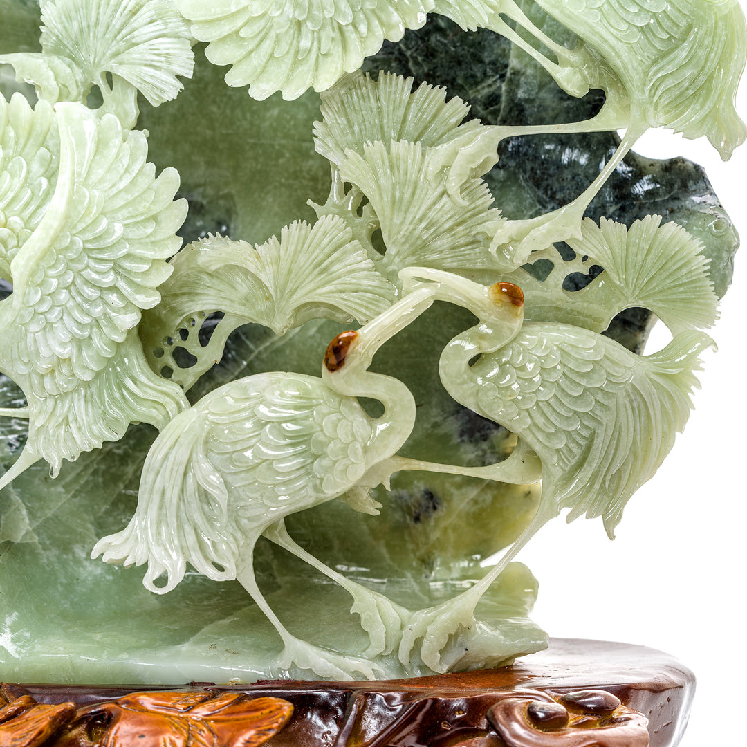 Serene agate cranes emerging from a rocky ledge backdrop.