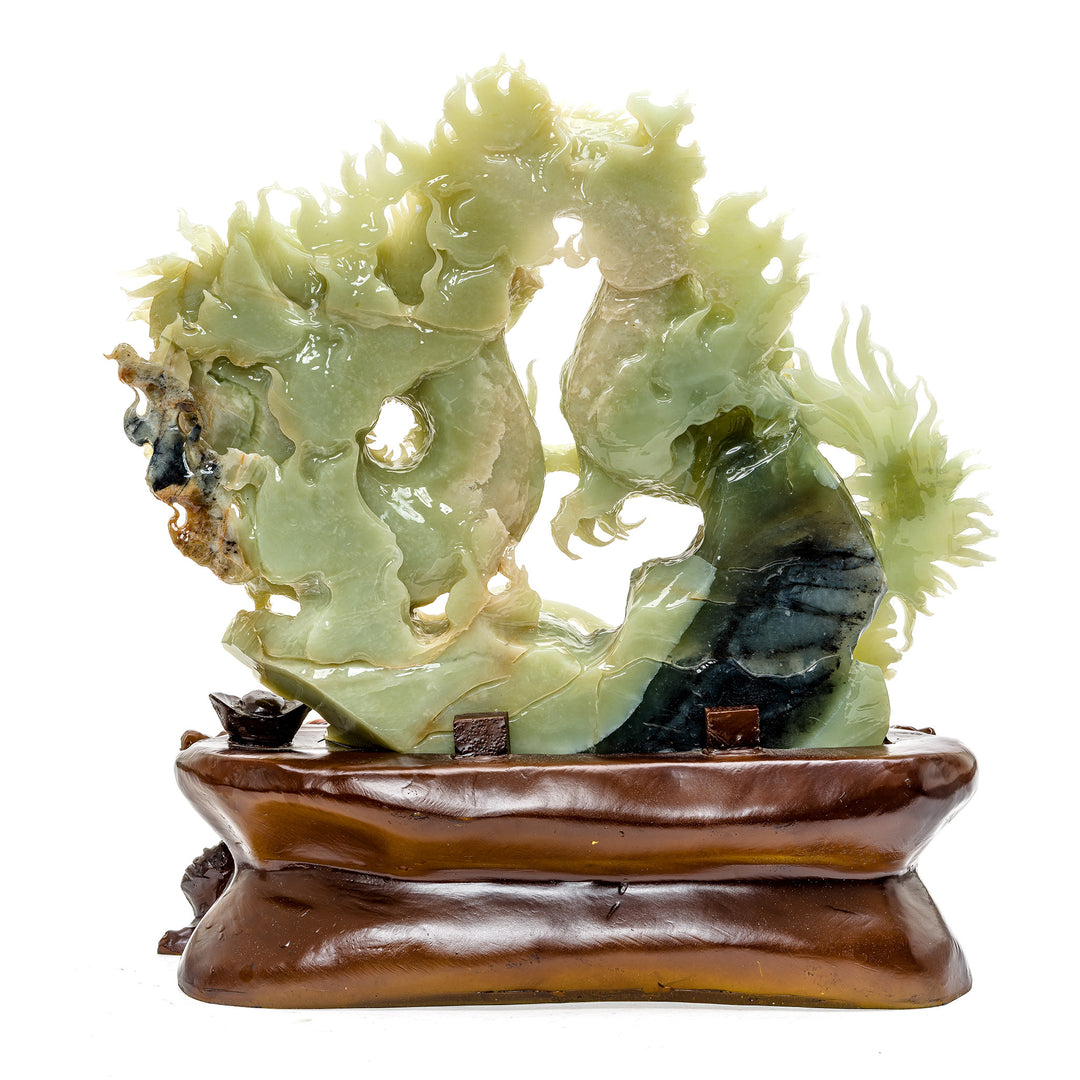 Artisanal carved dragon sculpture in green agate with wood detailing.