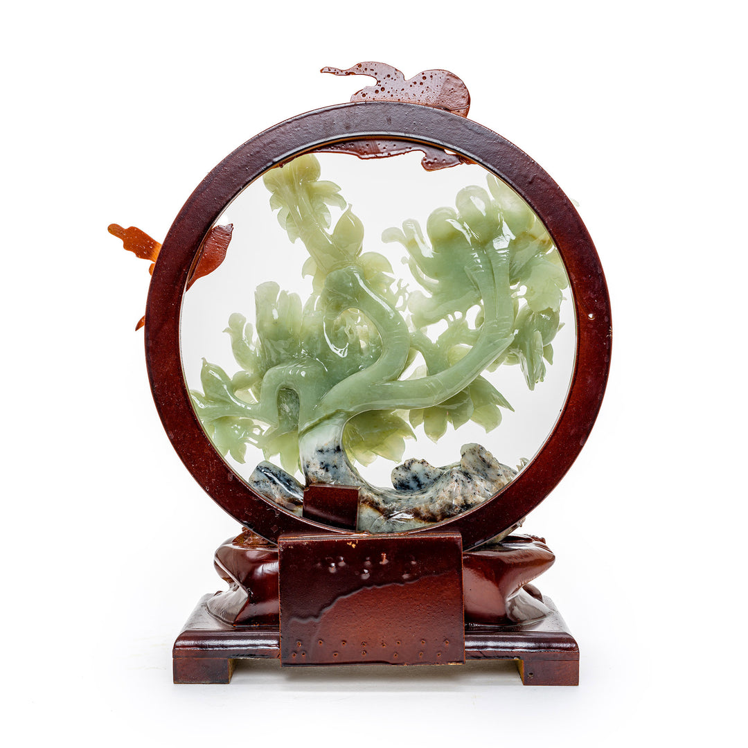 Enchanting agate sculpture of peonies with a moon and bird motif.
