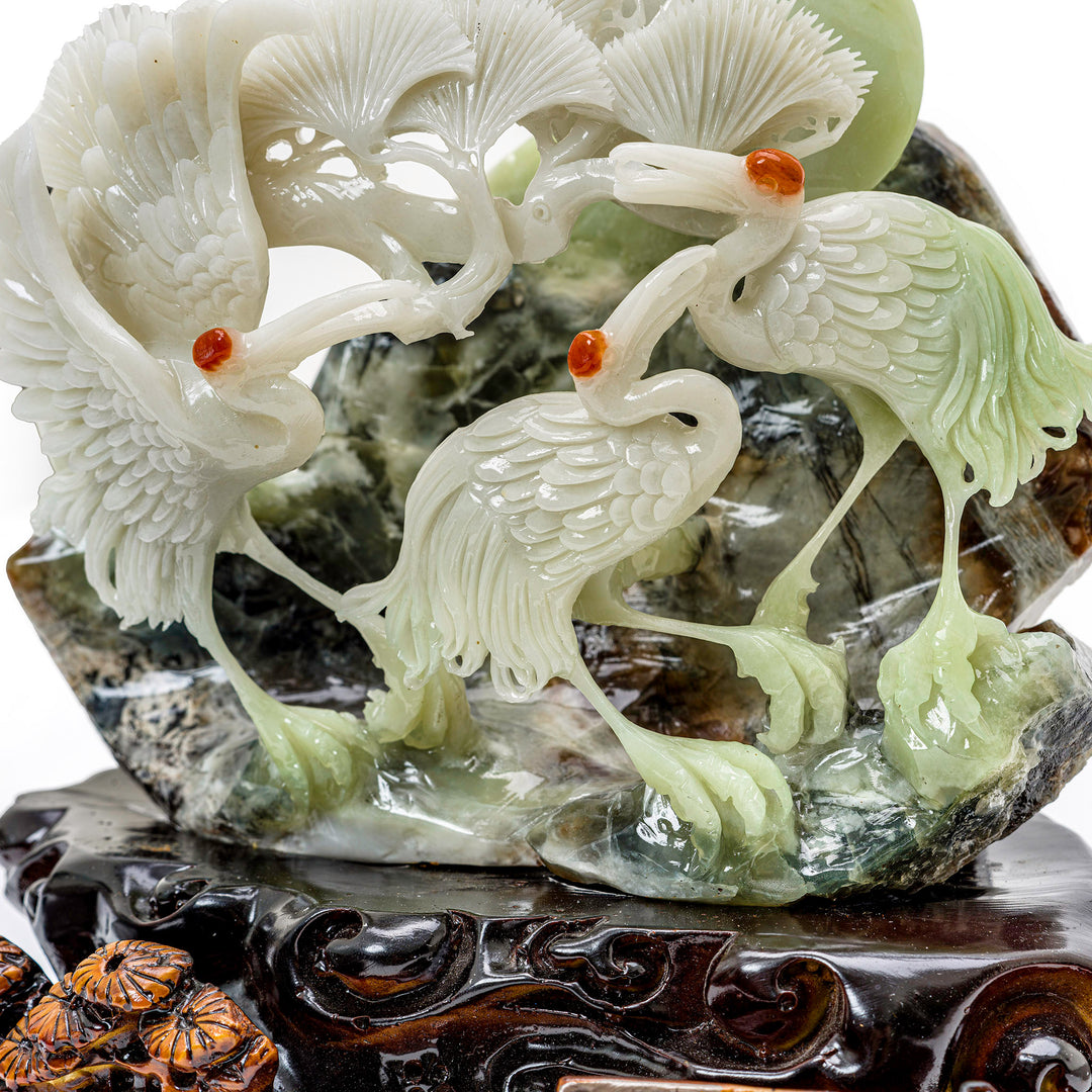 Artisan-carved crane group in agate, a piece of tranquility.