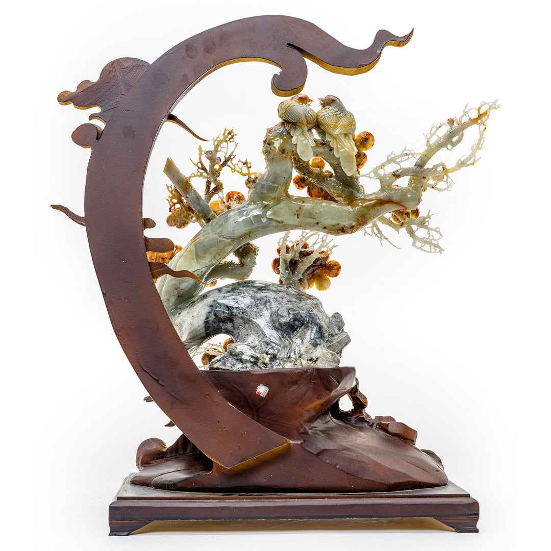 Intricate carving of agate peonies in full bloom, with wood display.