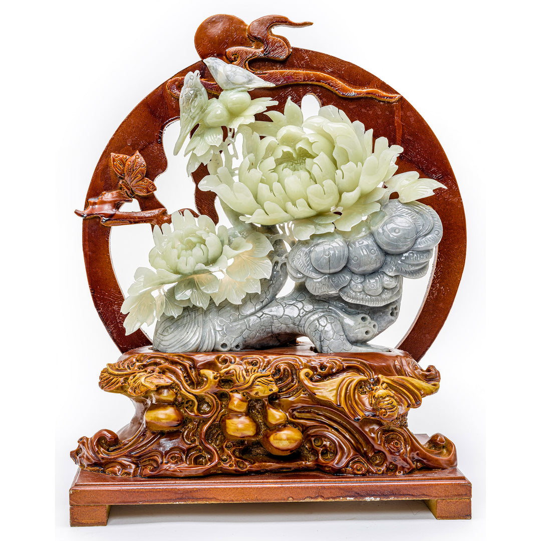 Agate sculpture of blooming peonies with birds on a carved wood base.