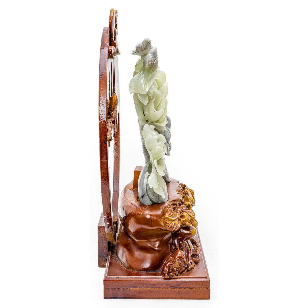 Blooming agate peony and bird sculpture on an ornate wooden stand.