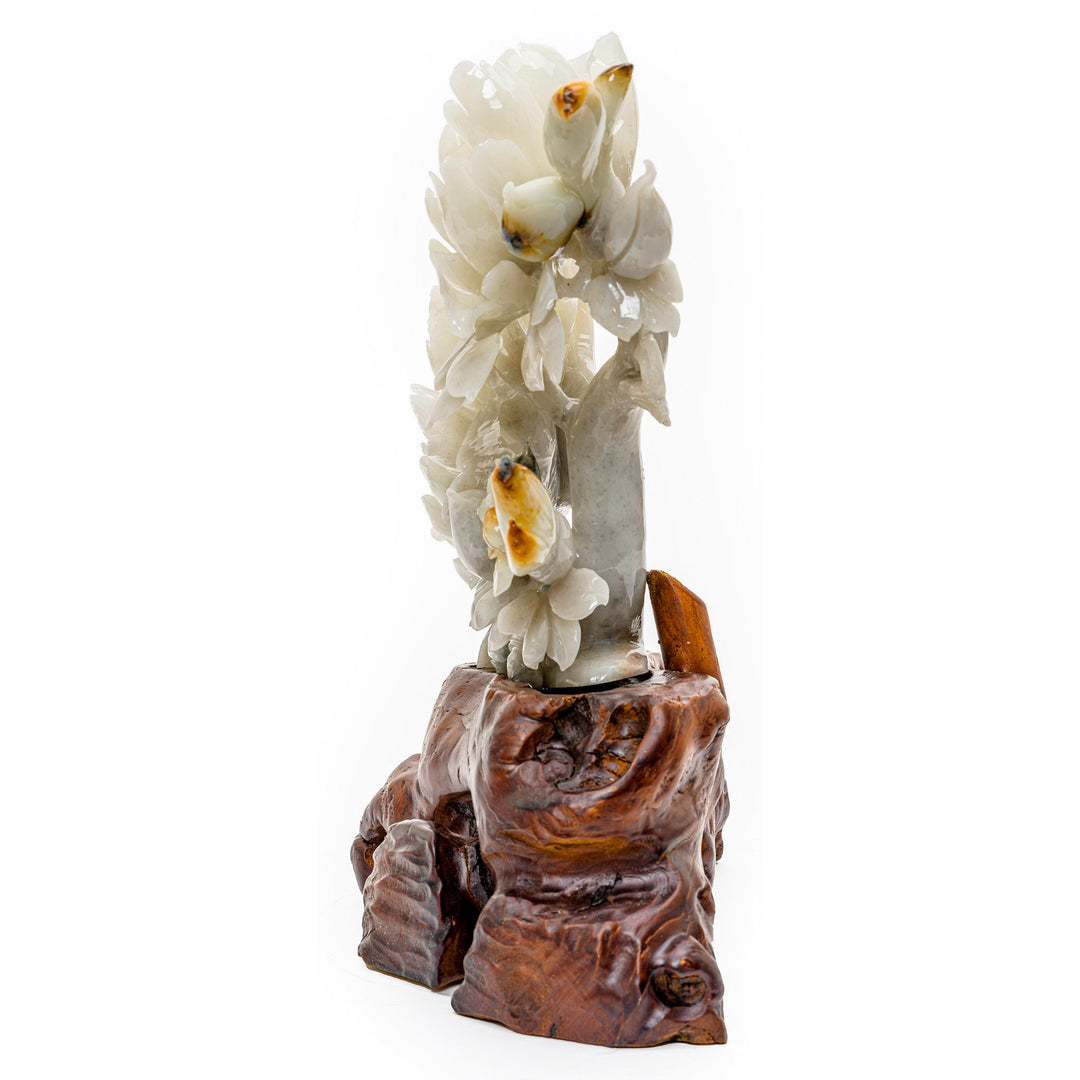 Agate carving of peony flowers with a bird atop, set on a carved base.