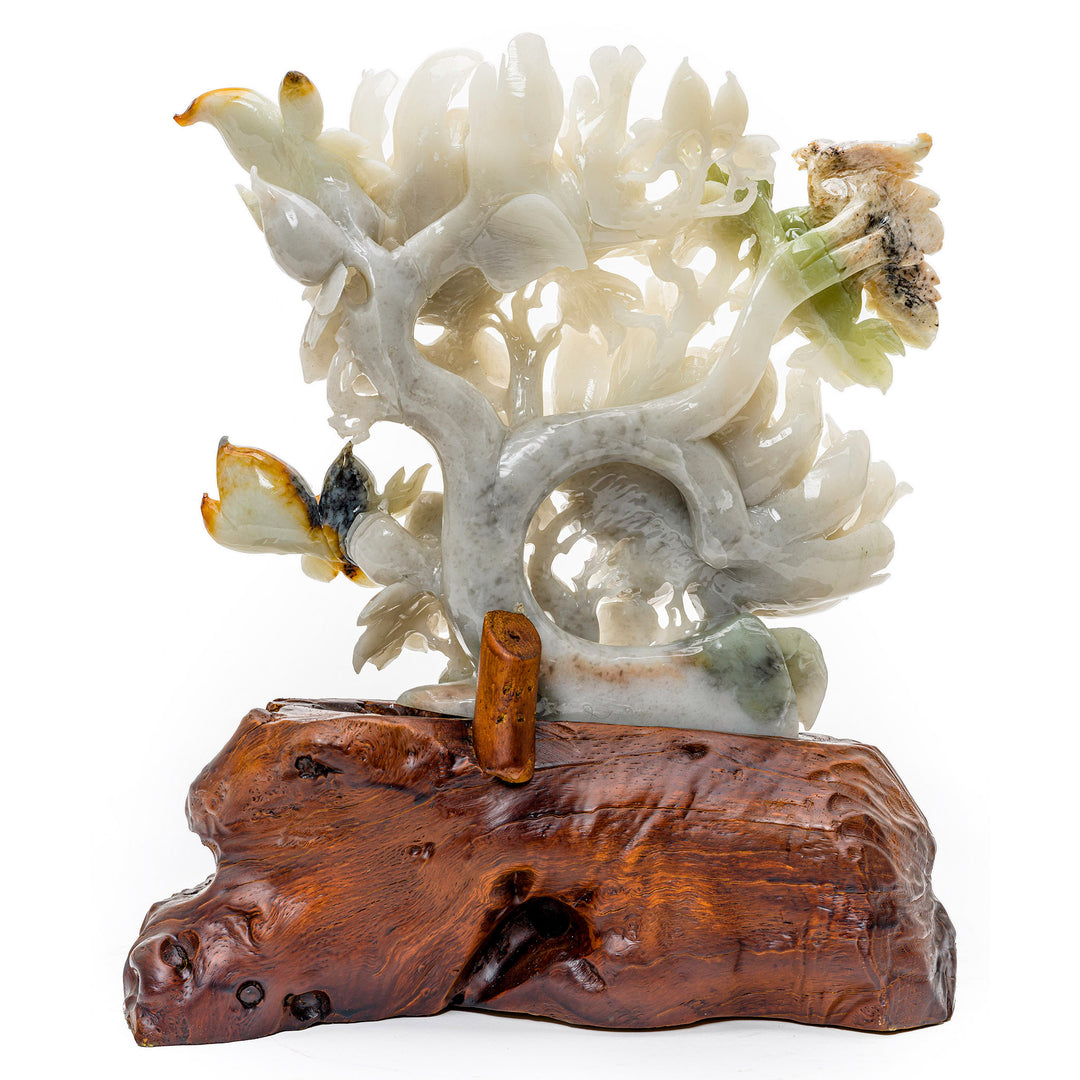 Artistic agate sculpture depicting blooming peonies and a bird in nature.