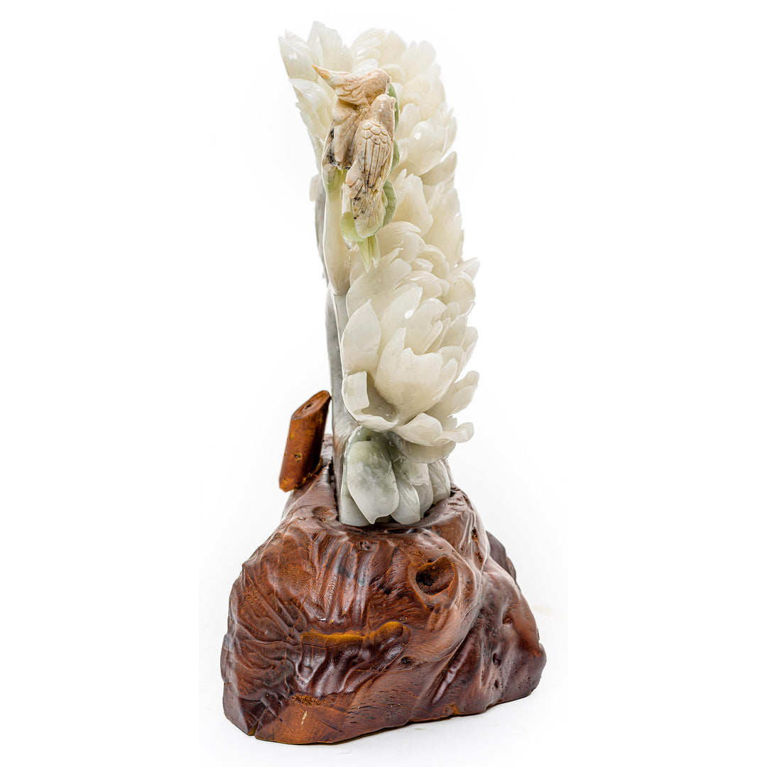 Nature-inspired agate and wood sculpture with peony blooms and a bird.