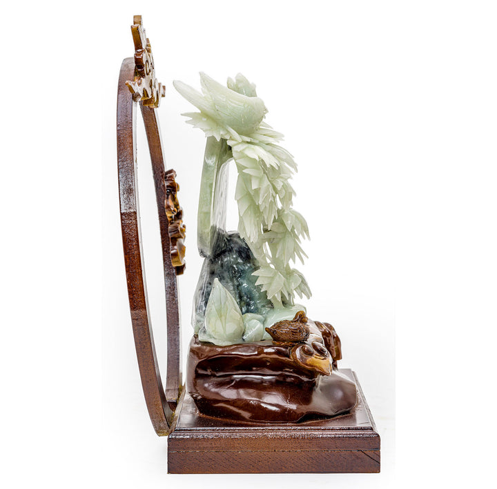 Nature-inspired bamboo and bird carving in agate set against a crescent moon.
