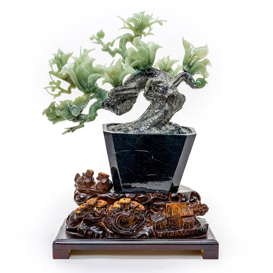 Hand-carved agate sculpture of blooming irises in a vase on a wood base.