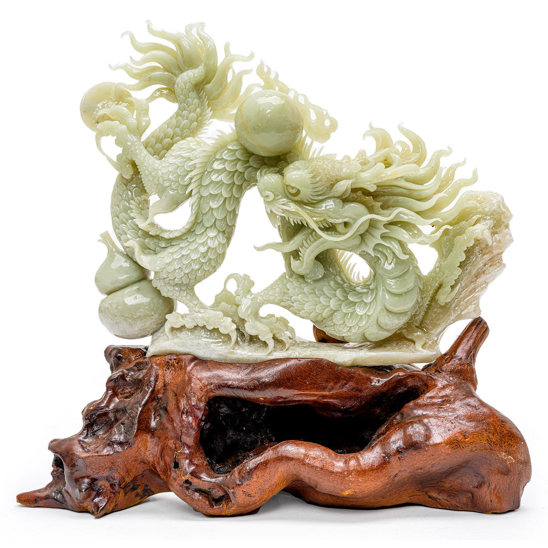 Hand-carved agate sculpture of a dragon with the Pearl of Wisdom on a wooden base.
