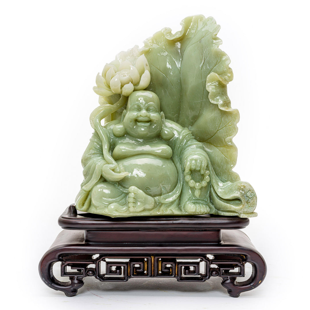 Hand-carved agate sculpture of a seated Buddha with scepter against a lotus flower.