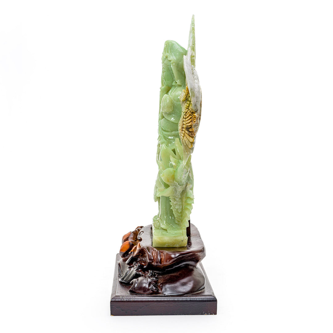 Serene Kwan Yin carved in agate, symbolizing compassion and surrounded by lotuses.