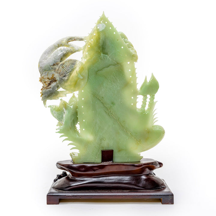 Artistic representation of Kwan Yin in agate, the Bodhisattva of kindness, with lotus flowers.