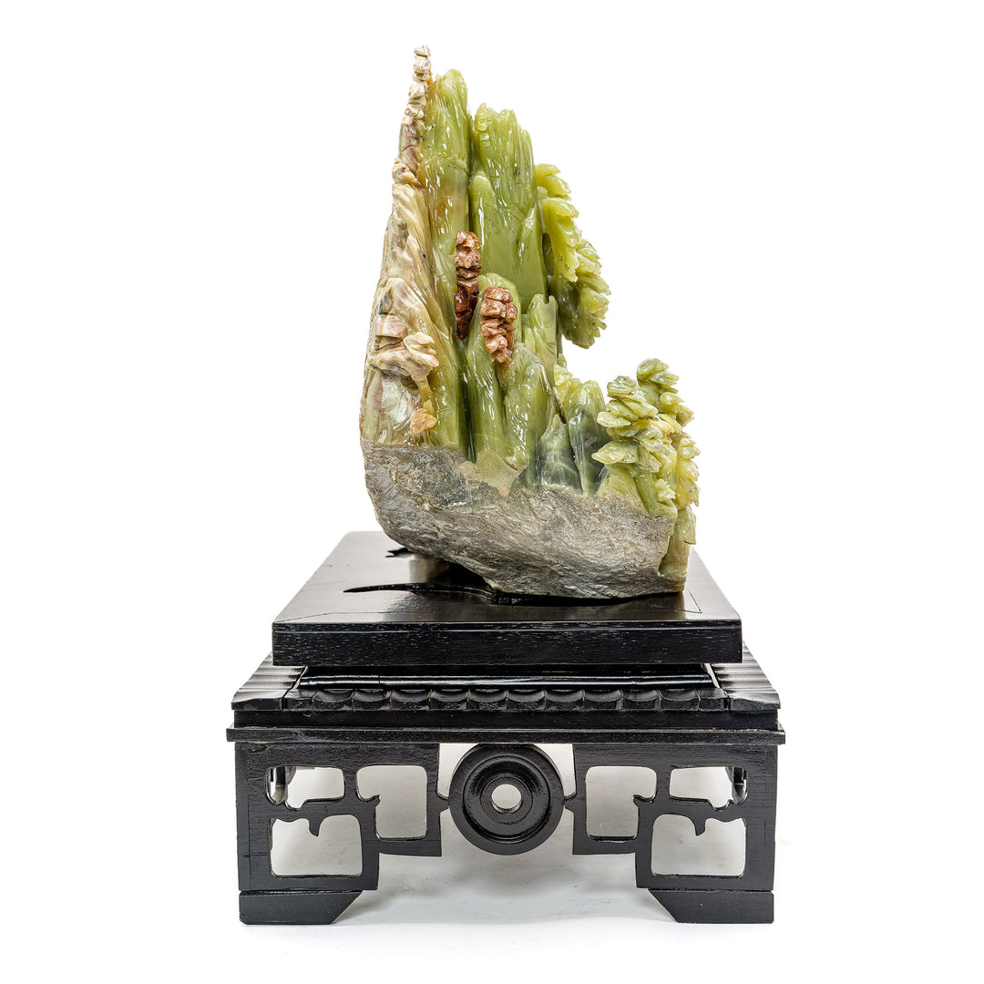 Agate mountainside village sculpture on a wooden stand
