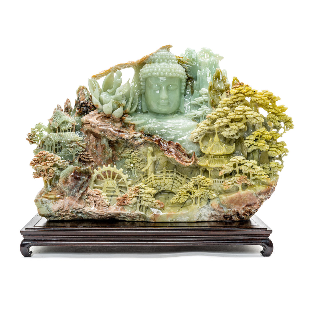 Carved Kwan Yin agate sculpture with mountain village