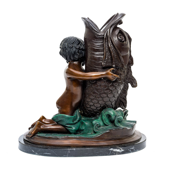 Serene bronze boy and fish sculpture