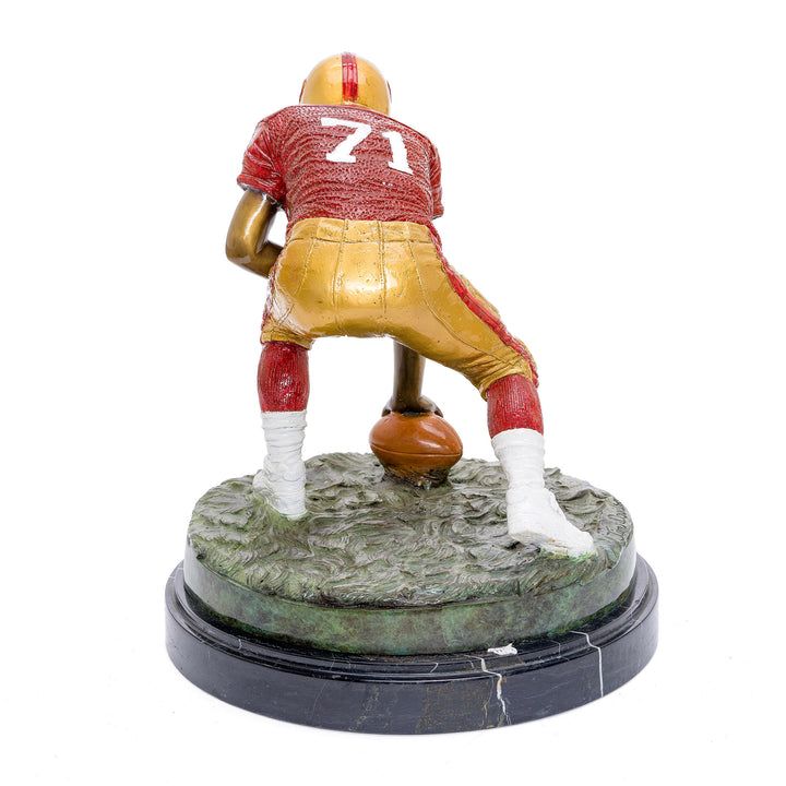 Ready stance football player in bronze with team colors.