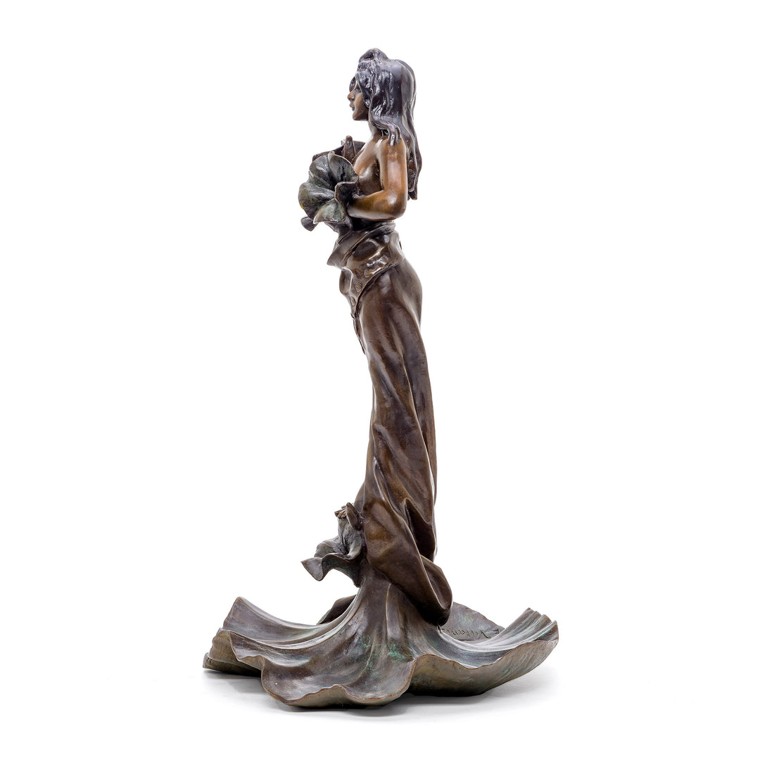 Graceful bronze statue of a woman on a lotus, symbolizing purity and enlightenment