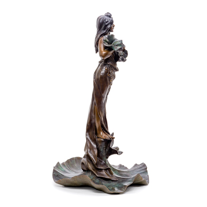 Artistic representation of a woman in bronze with lotus flowers, a serene decor piece