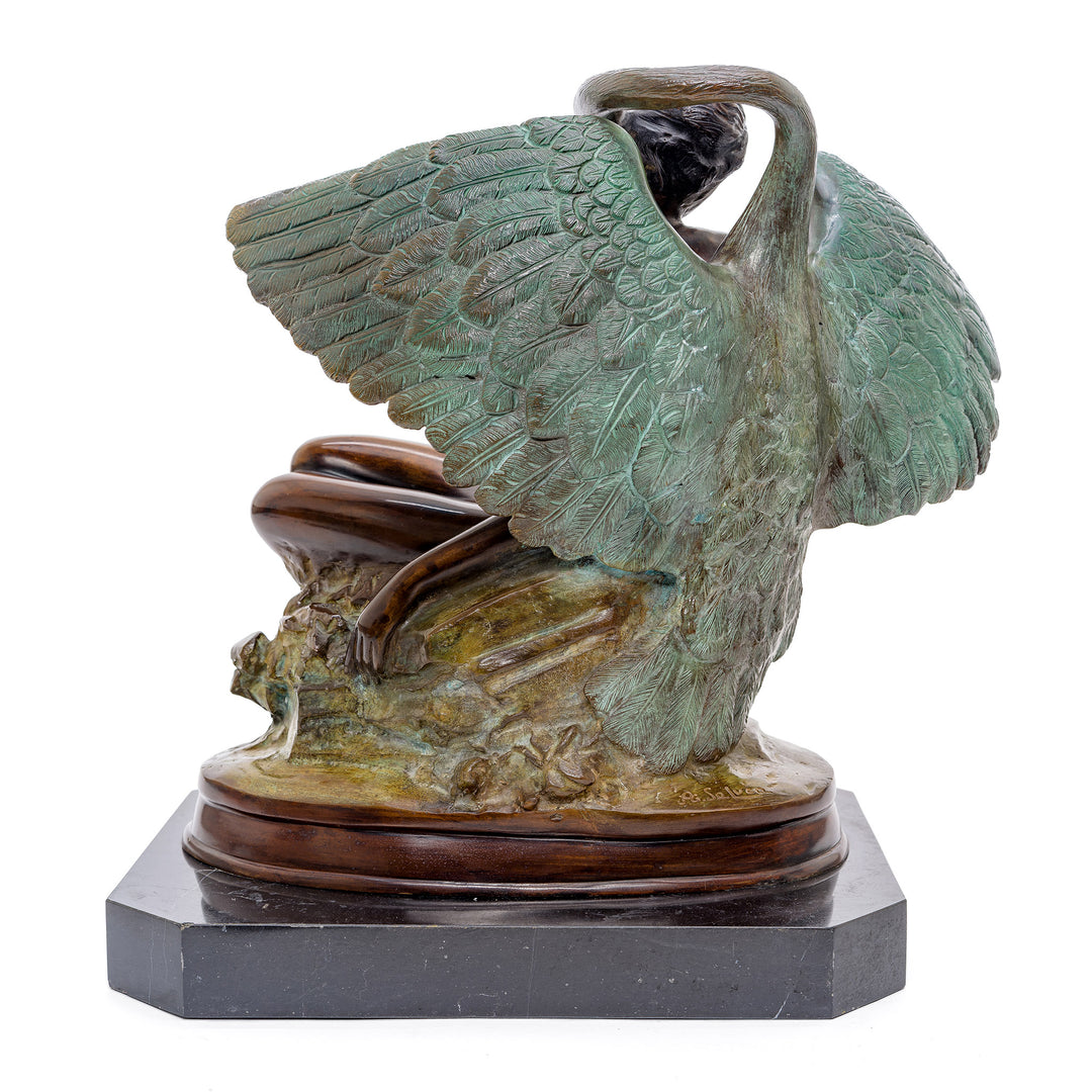 Artistic bronze rendition of a serene woman seated against a swan