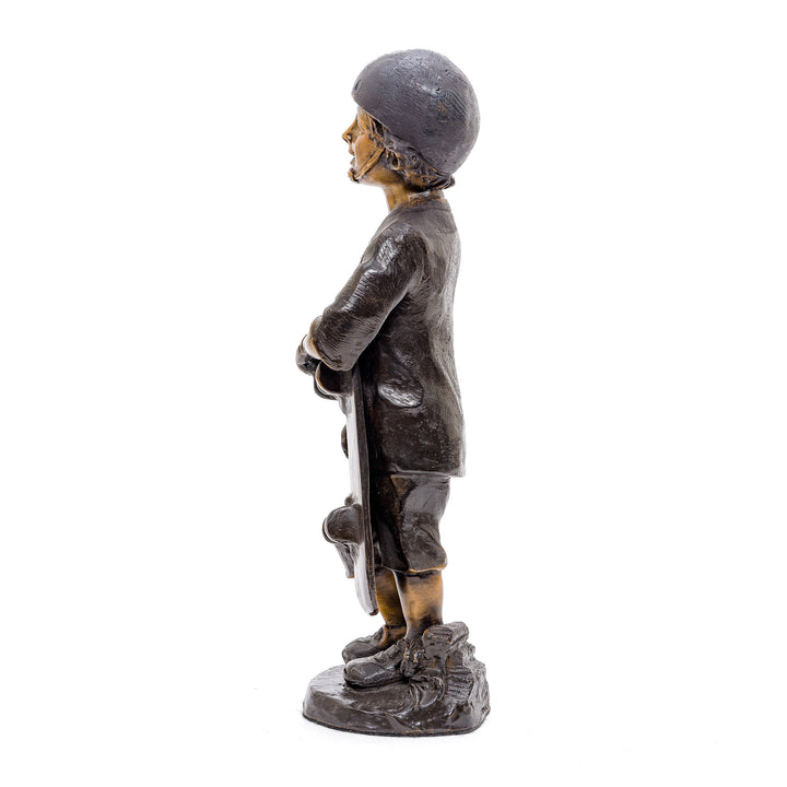 Artistic bronze depiction of a skateboard-holding boy, a nod to youthful zest